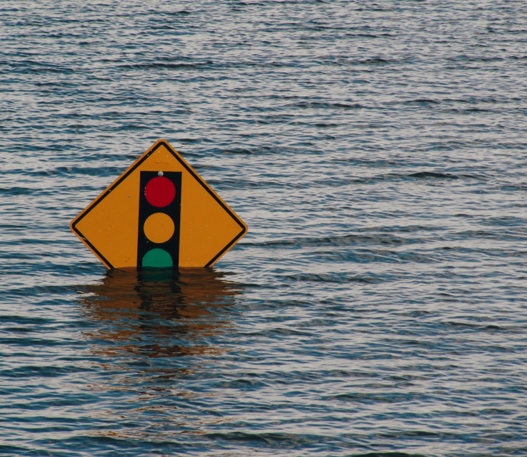 Traffic light road sign submerged in floodwater 
